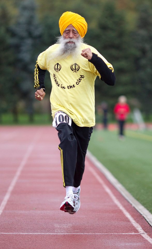Centenarian Fauja Singh crossing the finish line of a 100-meter race.
