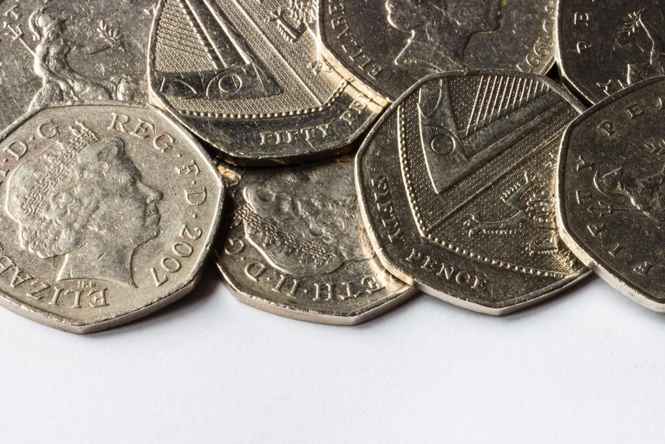 Pile of fifty pence pieces.