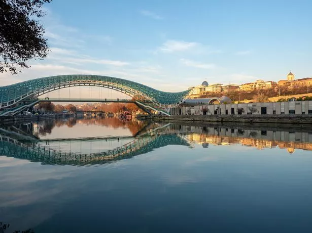 The Bridge of Peace is a bow-shaped pedestrian bridge, a steel and glass construction illuminated with numerous LEDs, over the Kura River in downtown Tbilisi, capital of Georgia.