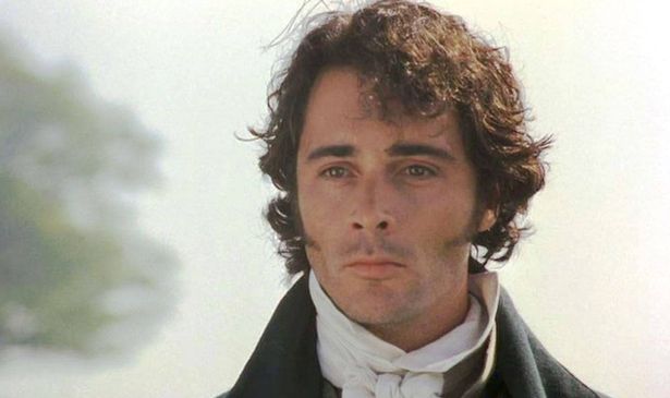 A man with dark hair in a cravat looks sad