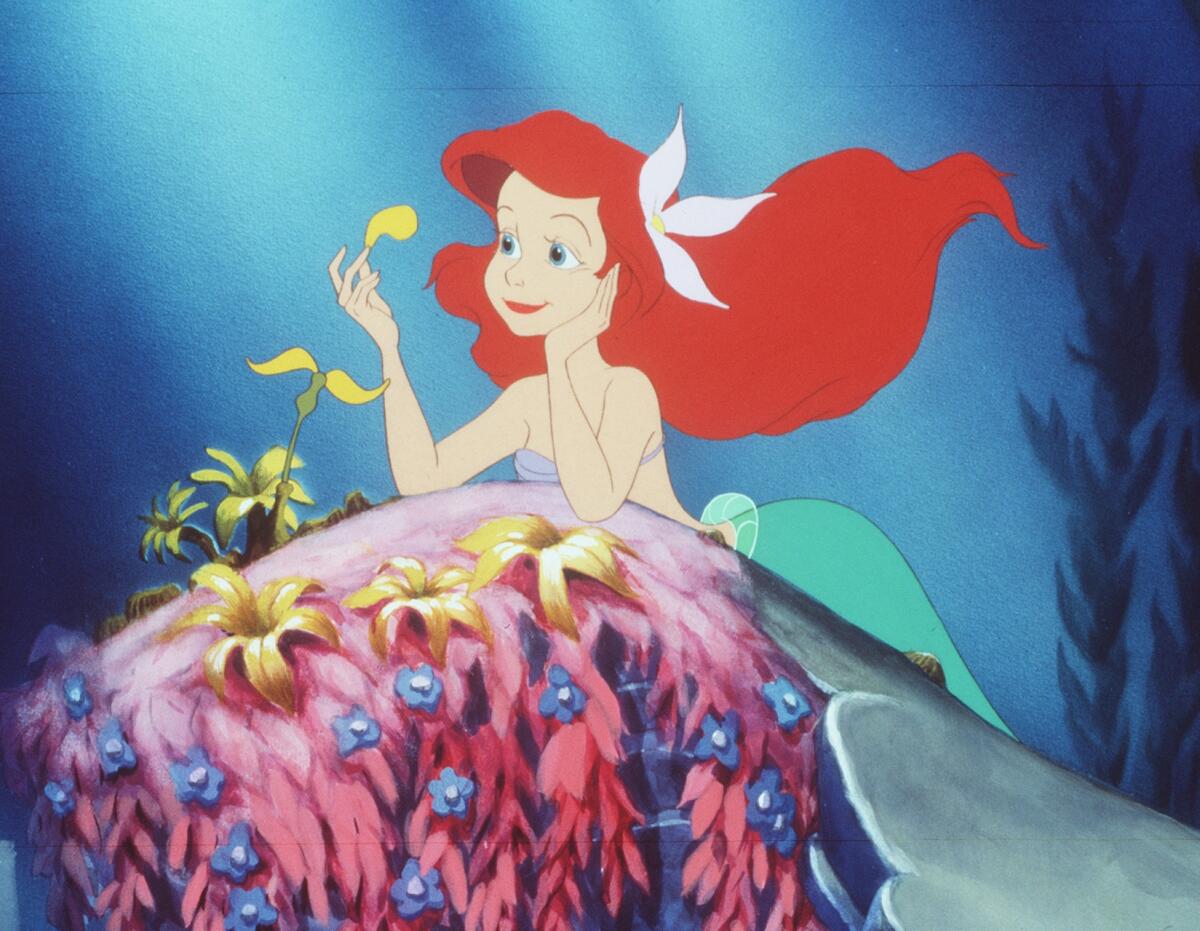 A mermaid with red hair is lost in thought.