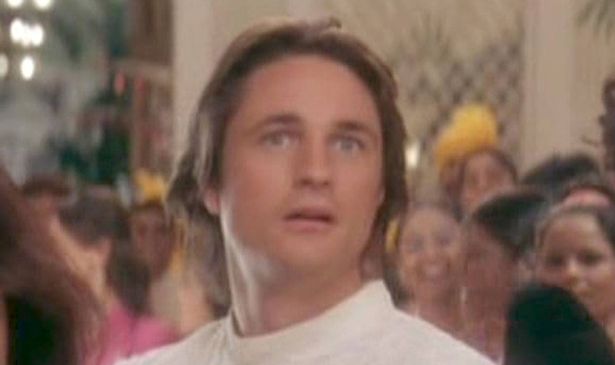 A man in white looks surprised 