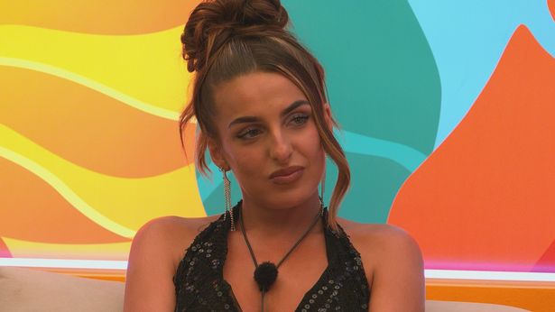 Love Island's Toni in a black outfit sat in the villa.