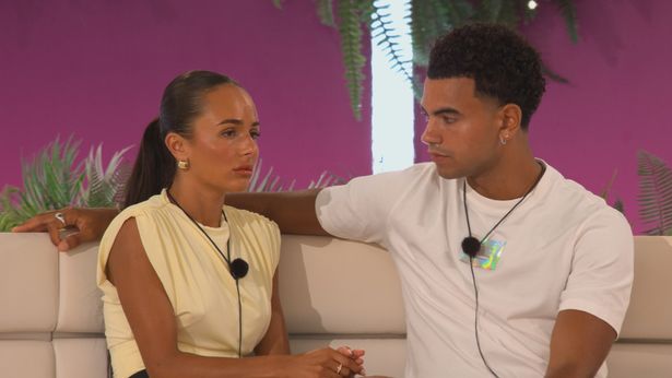 Love Island stars Lauren, in a yellow dress, and Harrison, in a white t-shirt, sat in the villa.