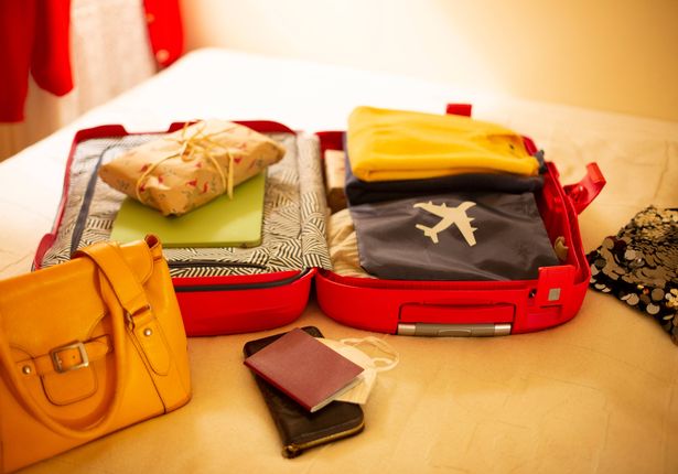 Packed suitcase lying open on bed
