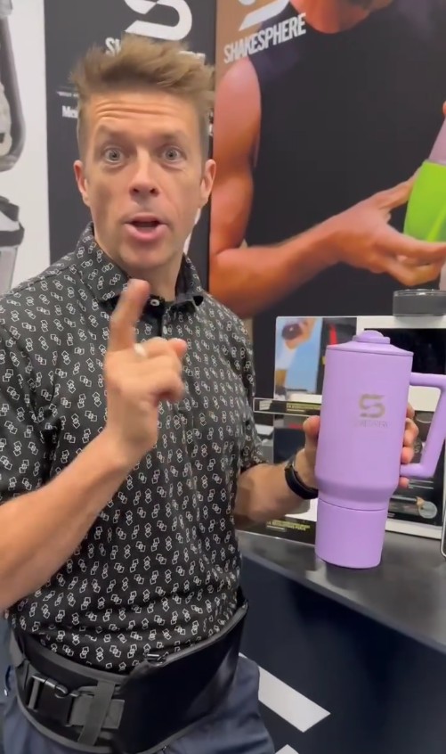 Man presenting a lavender ShakerSphere cup.
