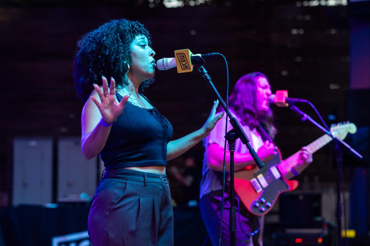 Woman singing in a band onstage