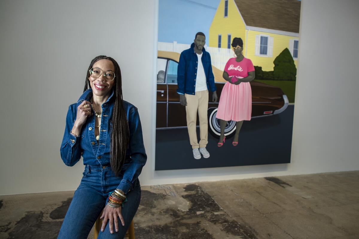 A woman in denim in front of a painting.