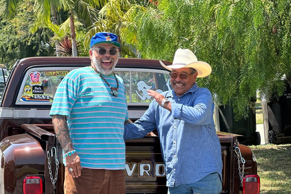 Chef Wes Avila stands next to his father, Jose Luis Avila, in front of a truck outdoors