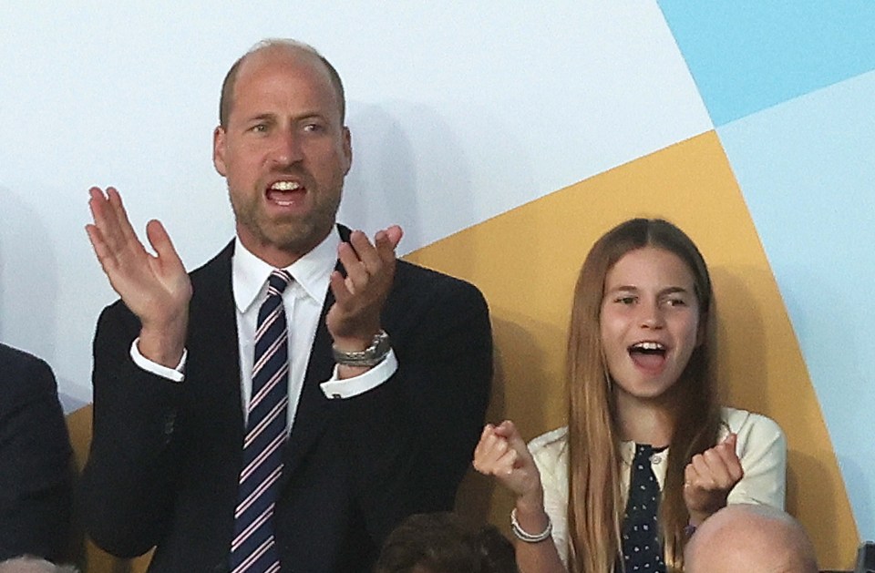 Prince William and Princess Charlotte watching a soccer match.