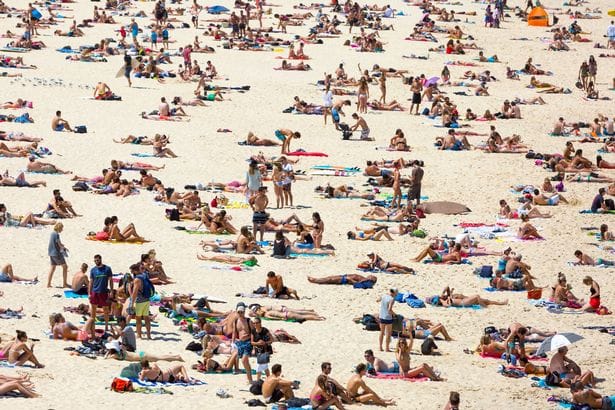 Crowded beach on a hot summer day, Bondi beach Sydney Australia, full frame horizontal composition