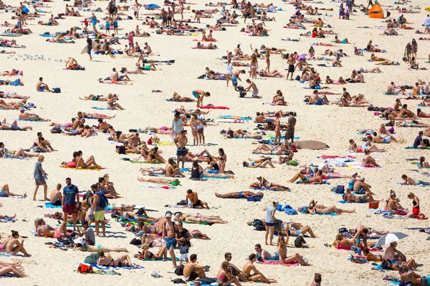 Crowded beach on a hot summer day, Bondi beach Sydney Australia, full frame horizontal composition