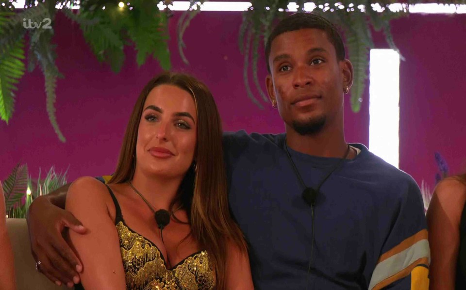 Screenshot of a couple sitting together on a show.