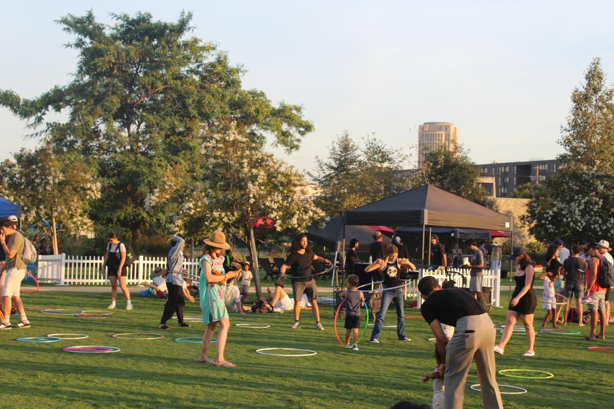 Attendees of the 2024 River Fest, hosted by Friends of the L.A. River, hula hoop at L.A. State Historic Park.