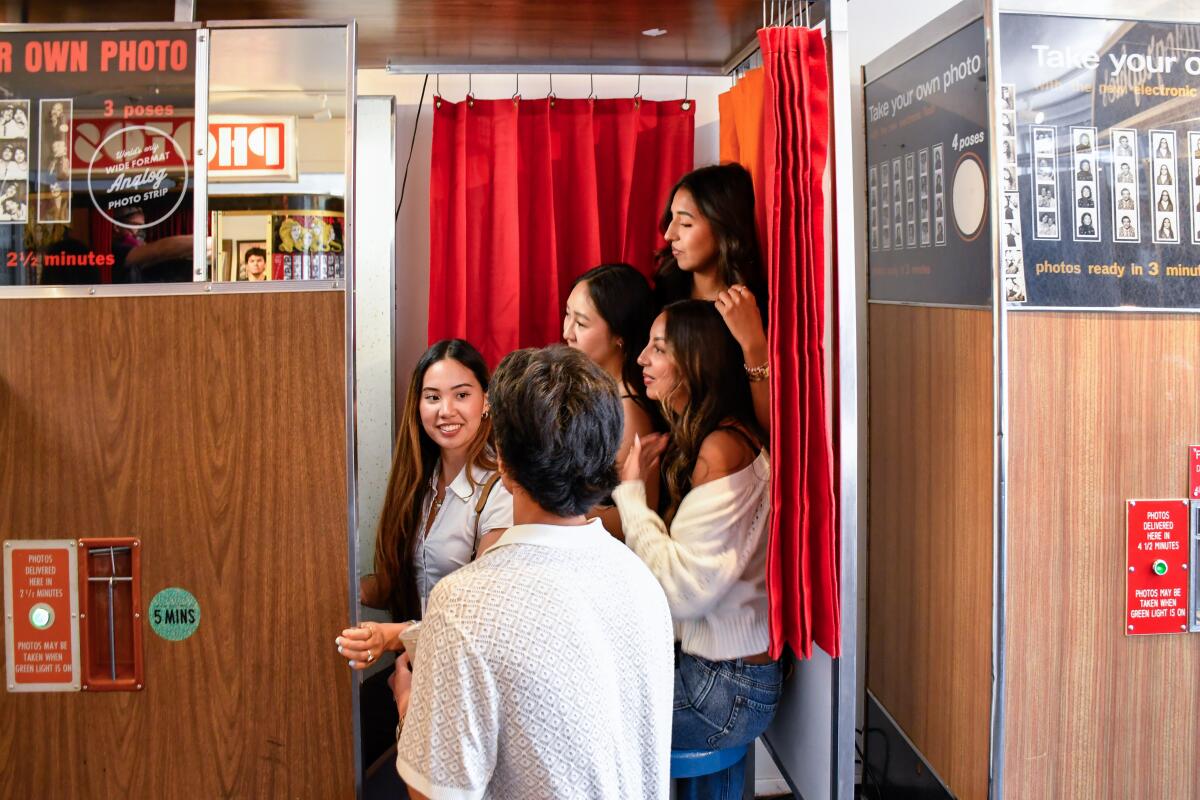 A birthday group gathers for a snapshot in the Photo Booth Museum, San Francisco.