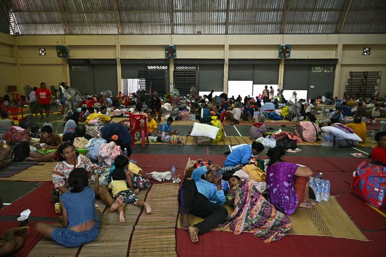 Evacuees rest as they take shelter in a gymnasium on the grounds of Surindra Rajabhat University in the Thai border province of Surin on July 25, 2025. More than 100,000 people have fled the bloodiest border fighting between Thailand and Cambodia in a decade, Bangkok said on July 25, as the death toll rose rises and international powers urged a halt to hostilities. (Photo by Lillian SUWANRUMPHA / AFP)Related conten