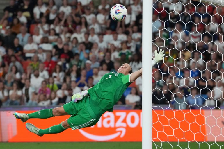 Germany goalkeeper Ann-Katrin Berger leaps to make a save during the Women's Euro 2025 quarterfinals soccer match between France and Germany at St. Jakob-Park in Basel, Switzerland, Saturday, July 19, 2025. (AP Photo/Martin Meissner)