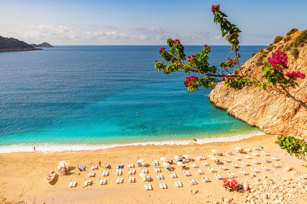 Kaputas beach in Antalya region, Turkey with clear turquoise water, sun umbrellas and sandy beach. Holiday or vacation resort