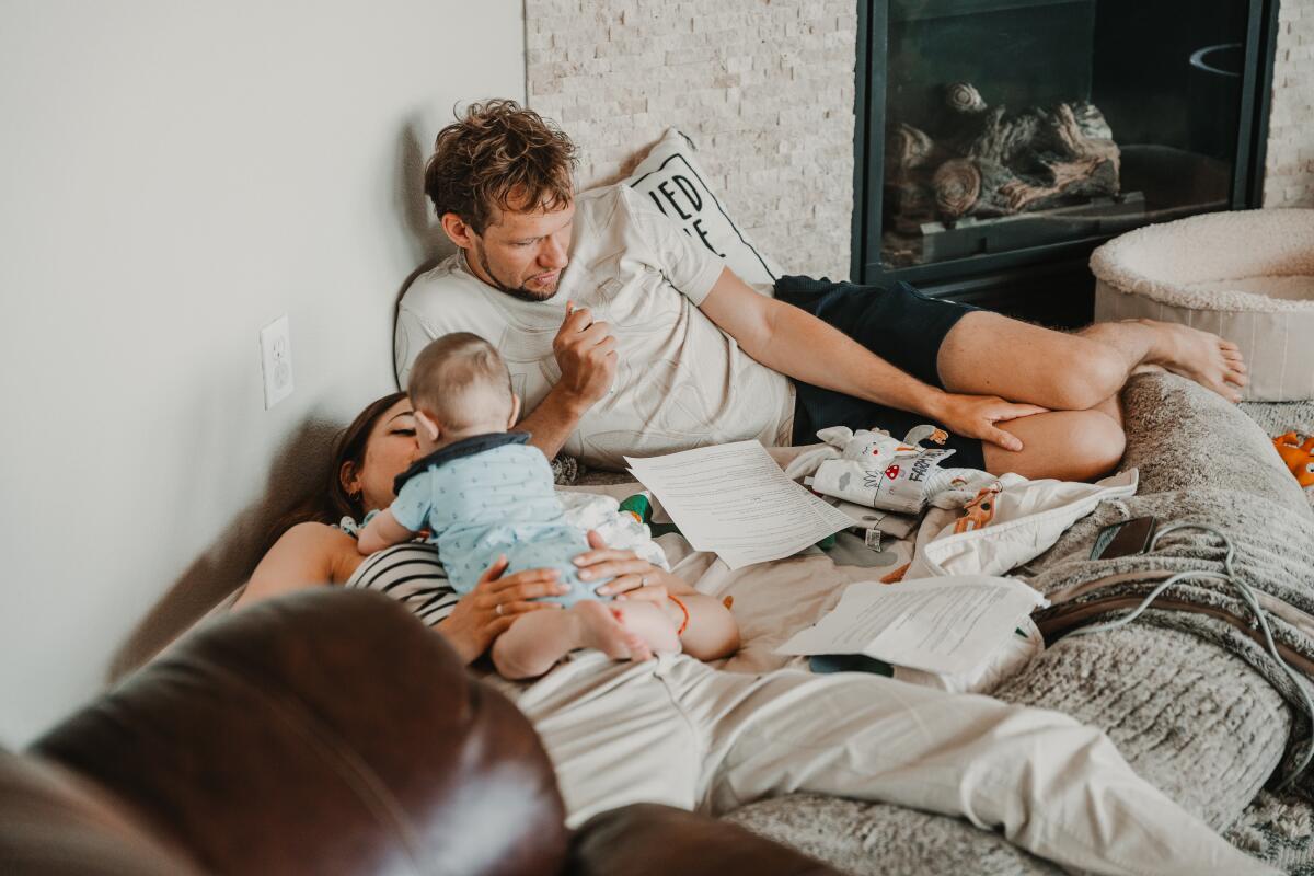 Amélie van Tass and Thommy Ten lounge in bed with their baby boy.