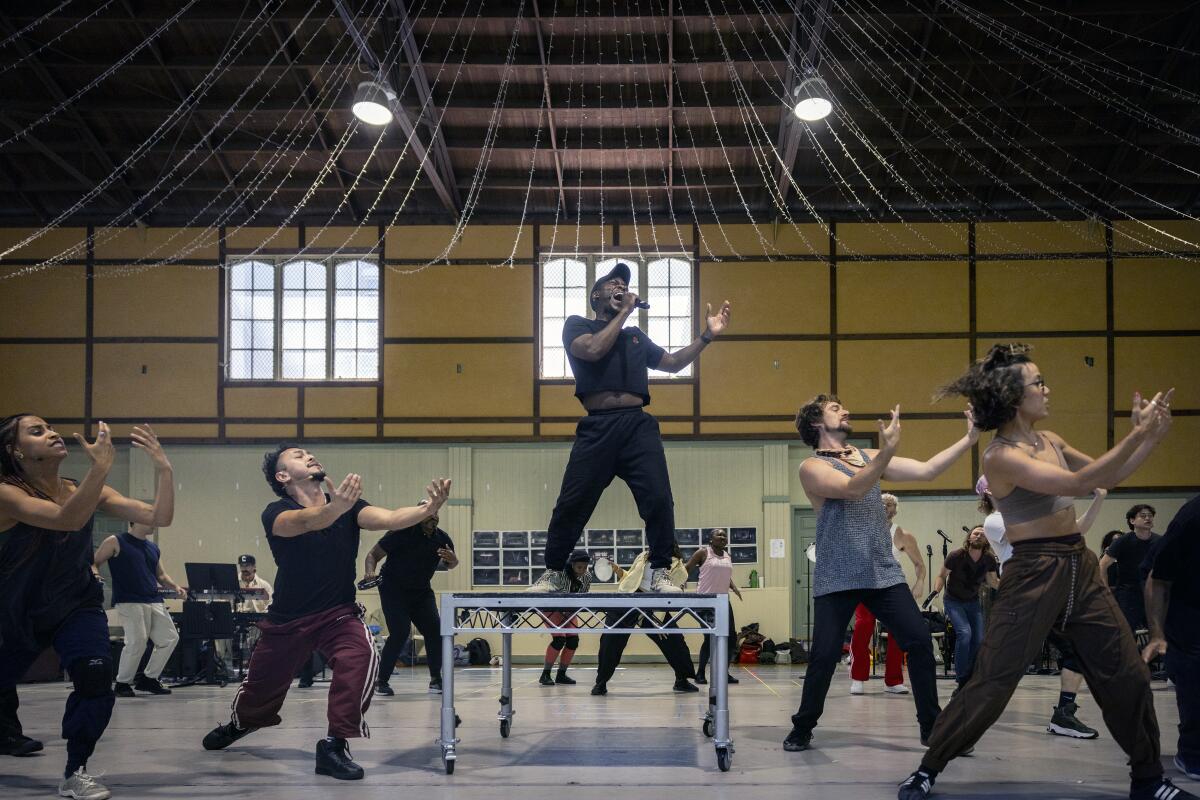 Tyrone Huntley performs on a table during a rehearsal.