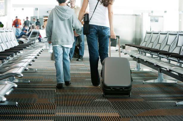 Mother and son walking in airport
