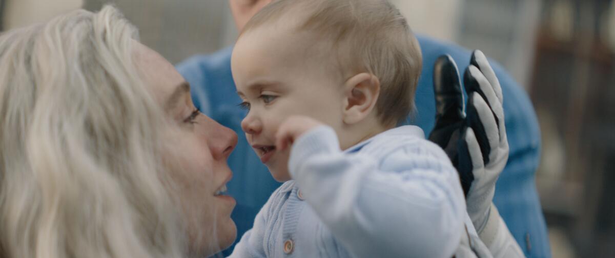 Vanessa Kirby's Sue Storm holds her baby in "The Fantastic Four: First Steps."