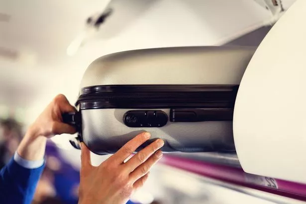 Hand-luggage compartment with suitcases in airplane
