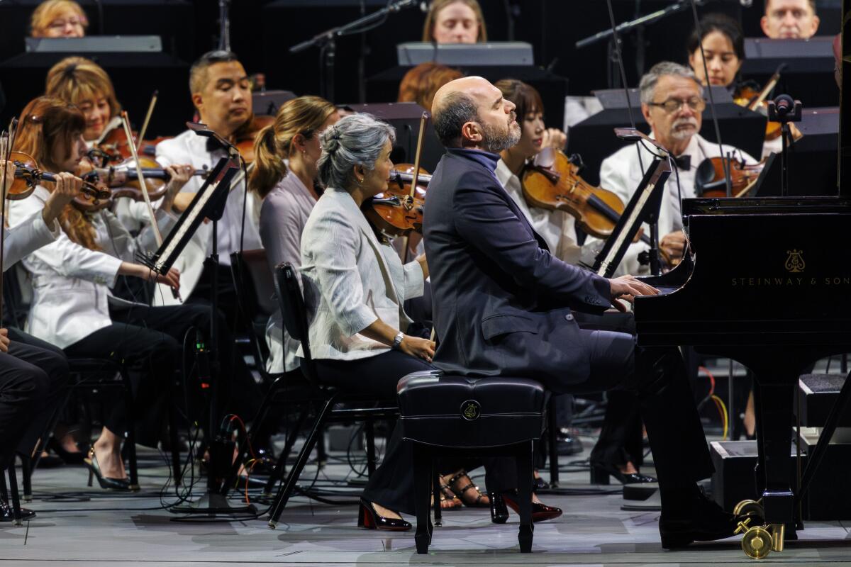 Kirill Gerstein performs on the piano as L.A. Philharmonic members accompany him on opening night at the Hollywood Bowl
