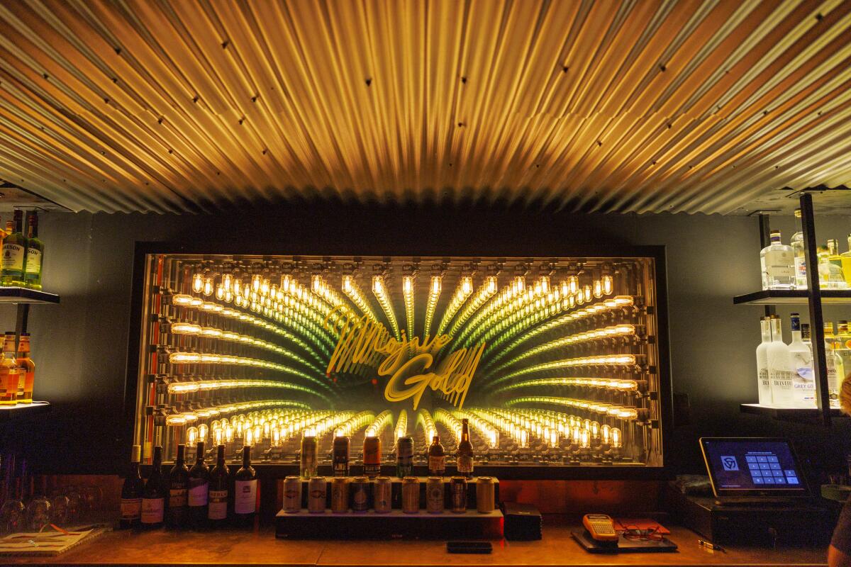 The bar inside the nightclub is decorated in gold colors at Mojave Gold.