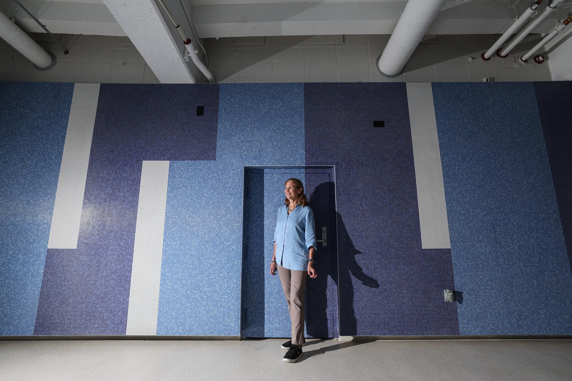 Janet Marie Smith, the Dodgers' executive vice president of planning and development, stands in front of the tile mural.
