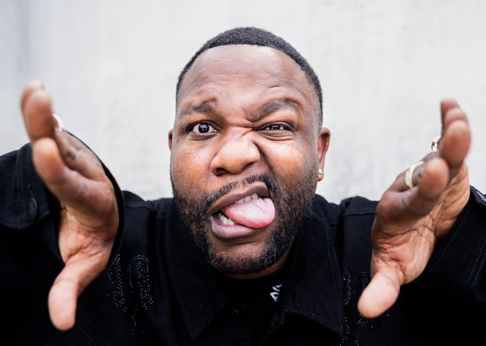 Man with his hands parted, making a funny face.