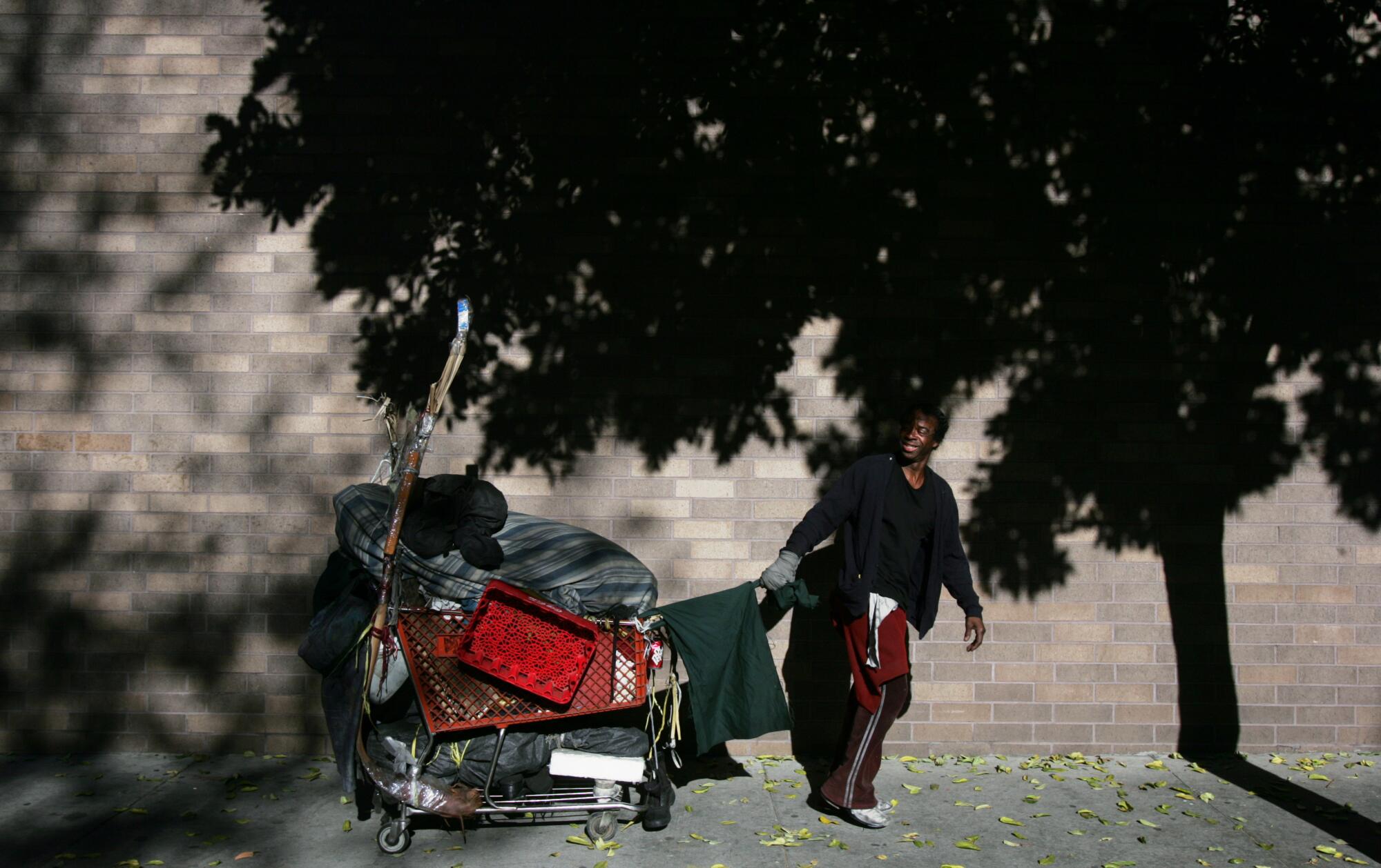 Ayers drags his cart in downtown Los Angeles.