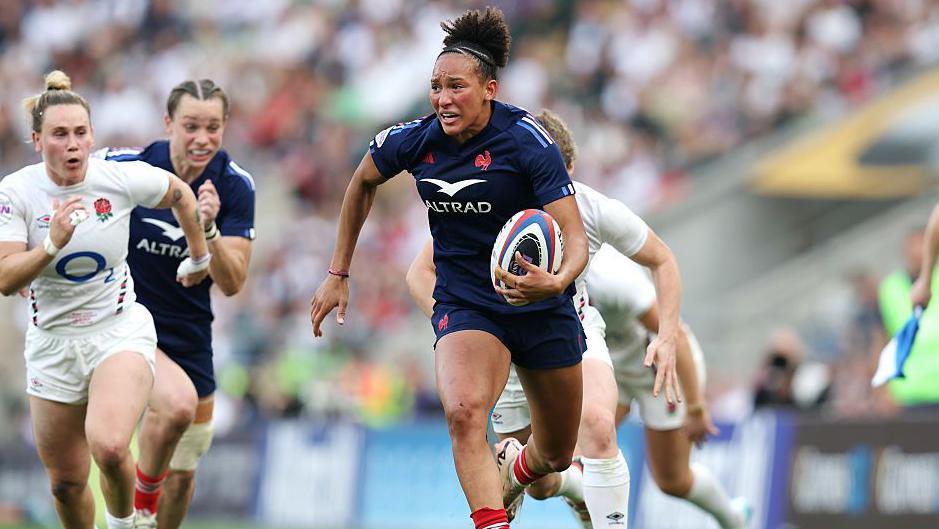 Kelly Arbey runs away for a try against England