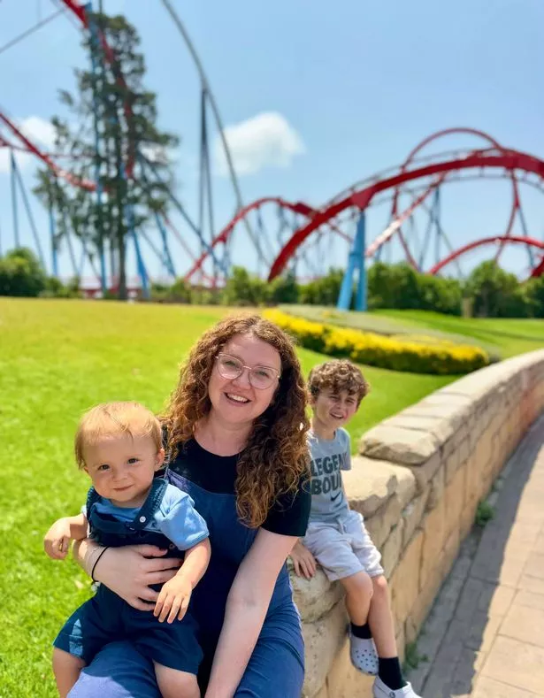 Jen and her children at Port Aventura in Spain
