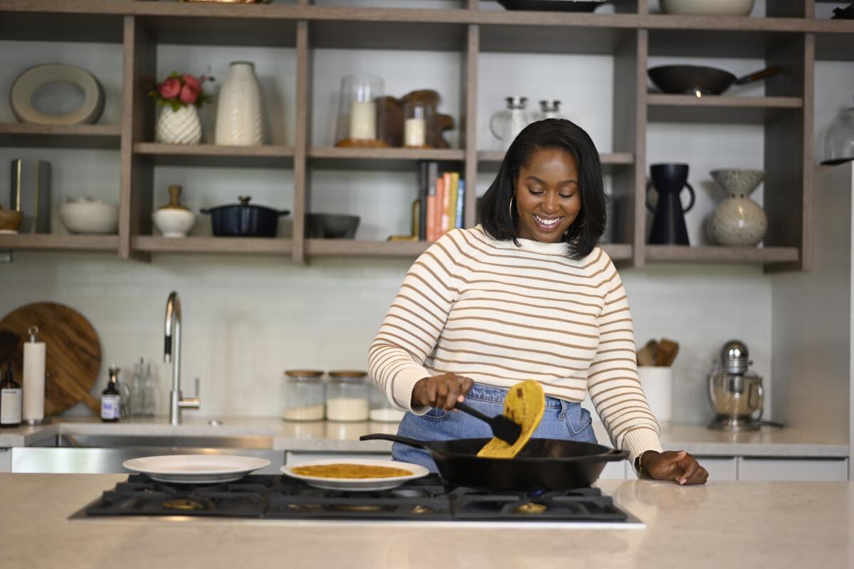 Kiano Moju pictured in the Los Angeles Times test kitchen, preparing pumpkin chapati for an episode of "Chef That!" 