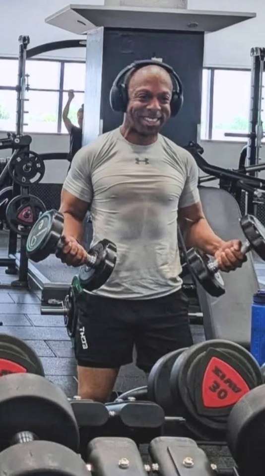 Man lifting weights in a gym.