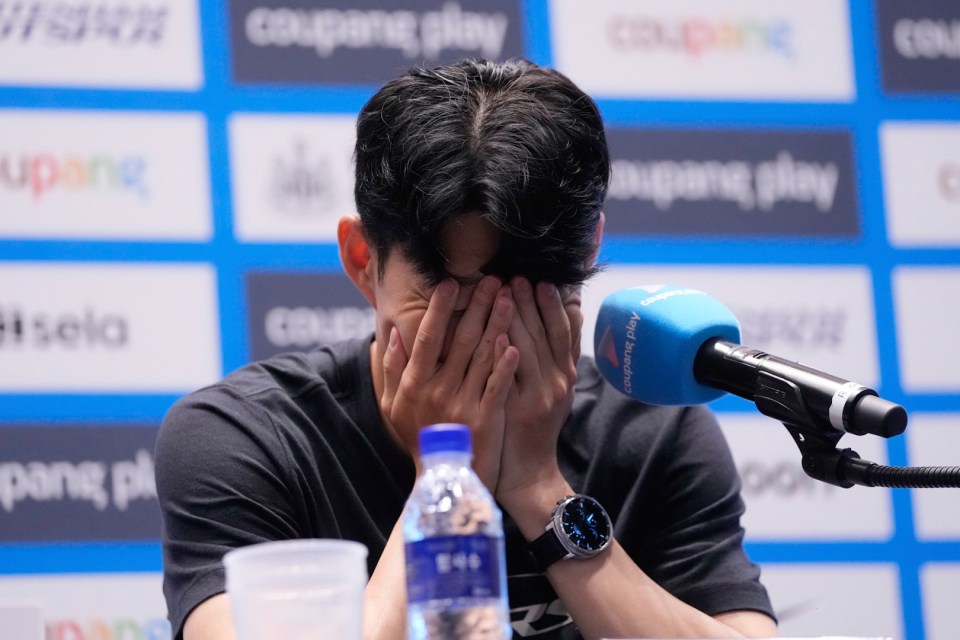 Son Heung-min at a press conference, head in hands.
