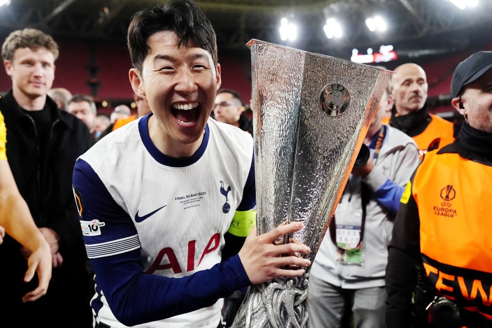 Son Heung-Min holding the Europa League trophy.