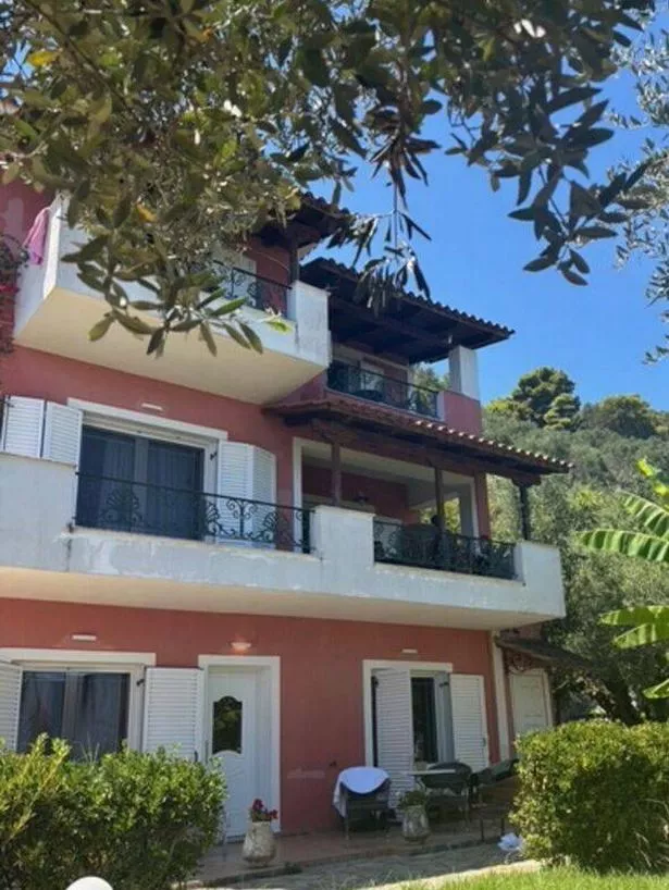 A three storey peach coloured villa