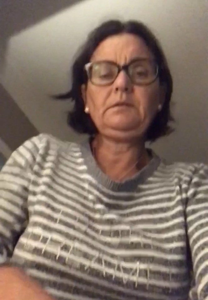 Woman wearing glasses and a striped sweater.