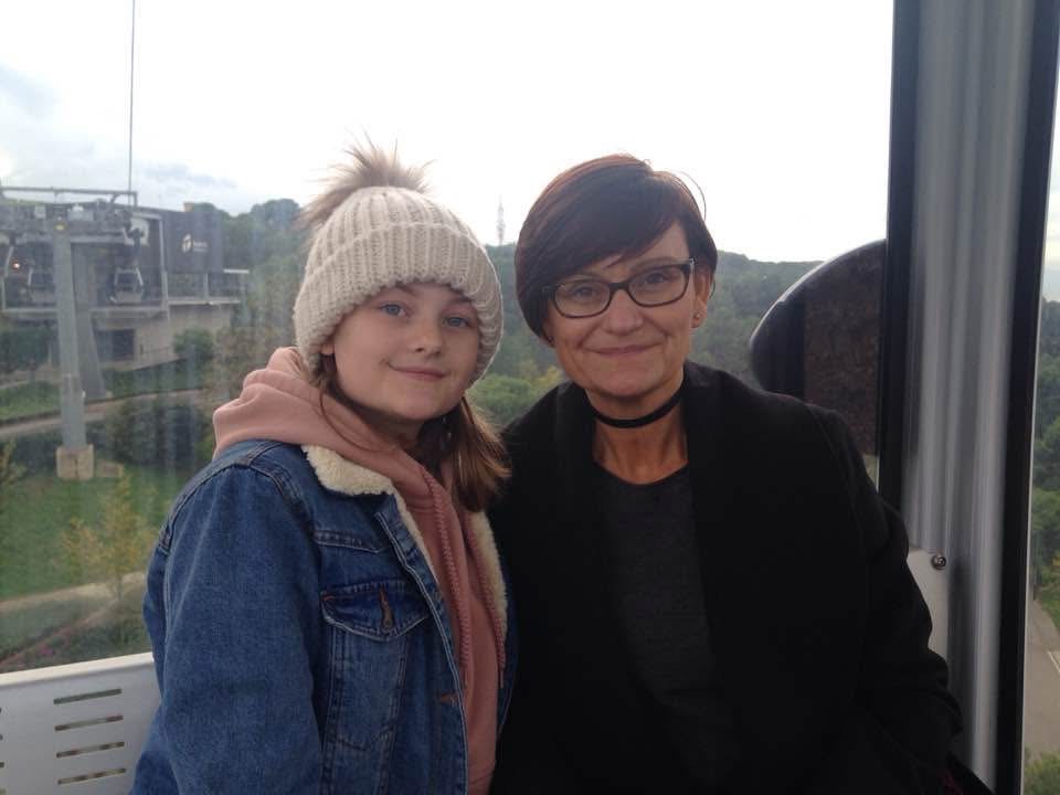A woman and a girl in a cable car.