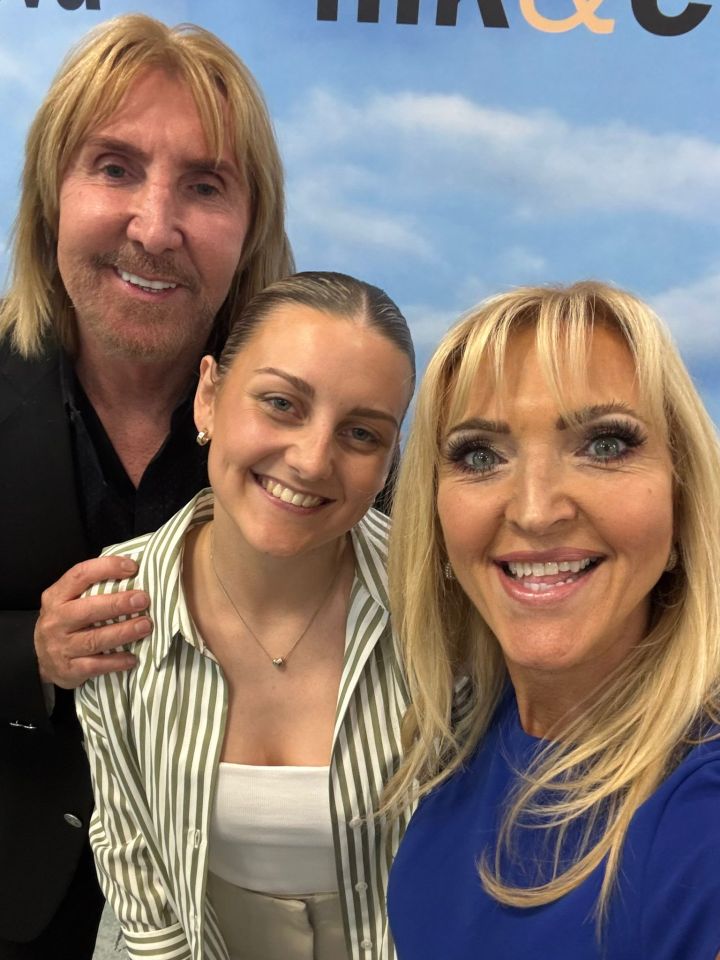 Selfie of three people smiling.