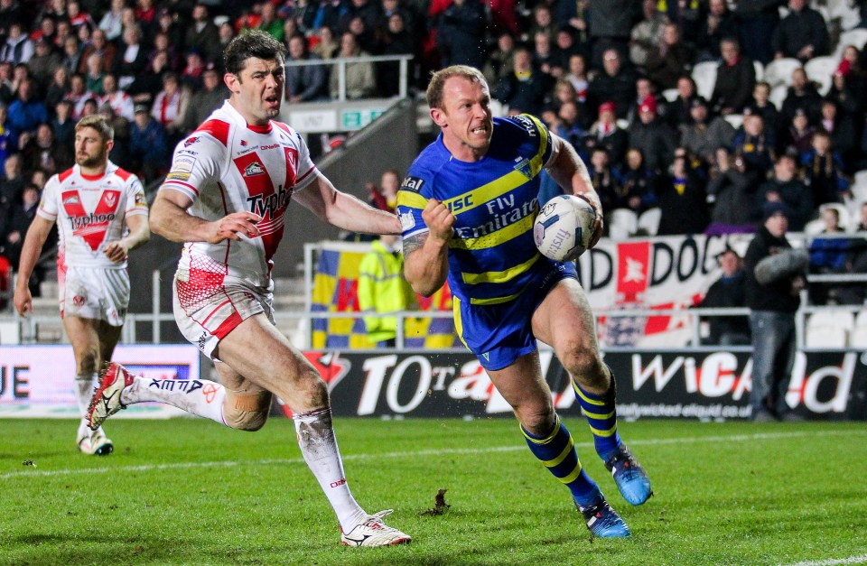 Rugby player running with the ball during a St Helens v Warrington Wolves match.