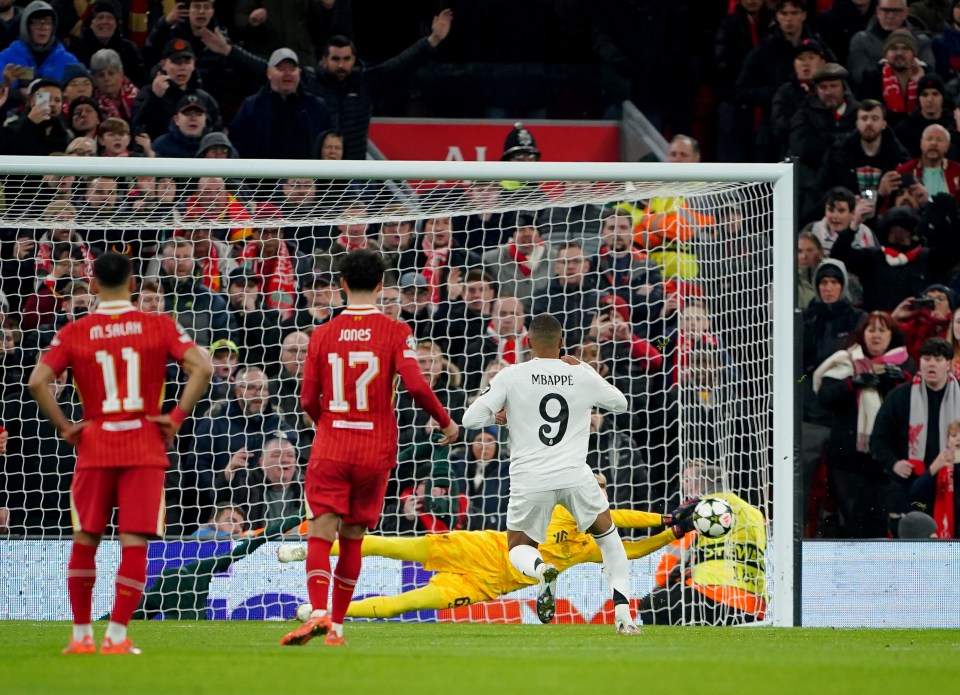 Liverpool's goalkeeper saves a penalty kick from Real Madrid's Kylian Mbappé.