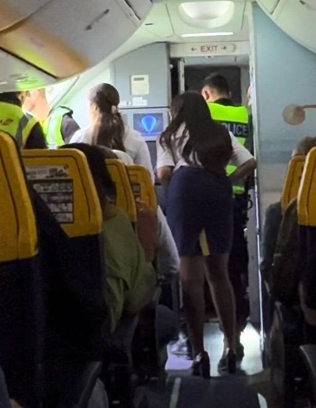 The 21-year-old lad being escorted off a plane by six cops for allegedly vaping in the loo