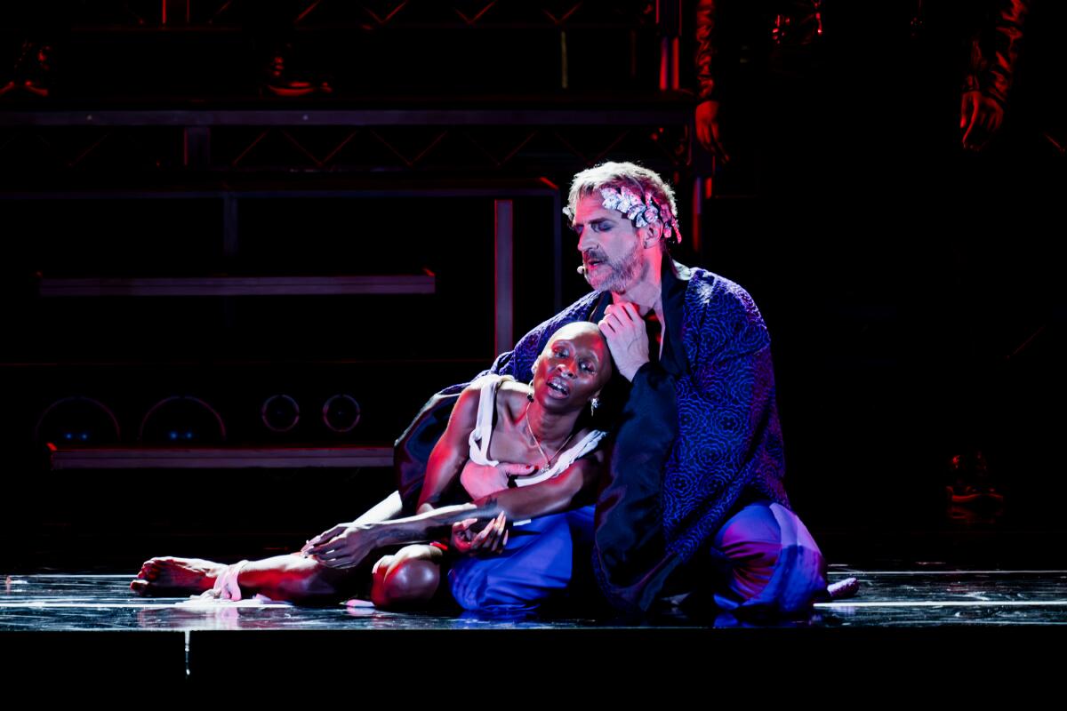 Raul Esparza as Pontius and Cynthia Erivo as Jesus sit on stage in "Jesus Christ Superstar."