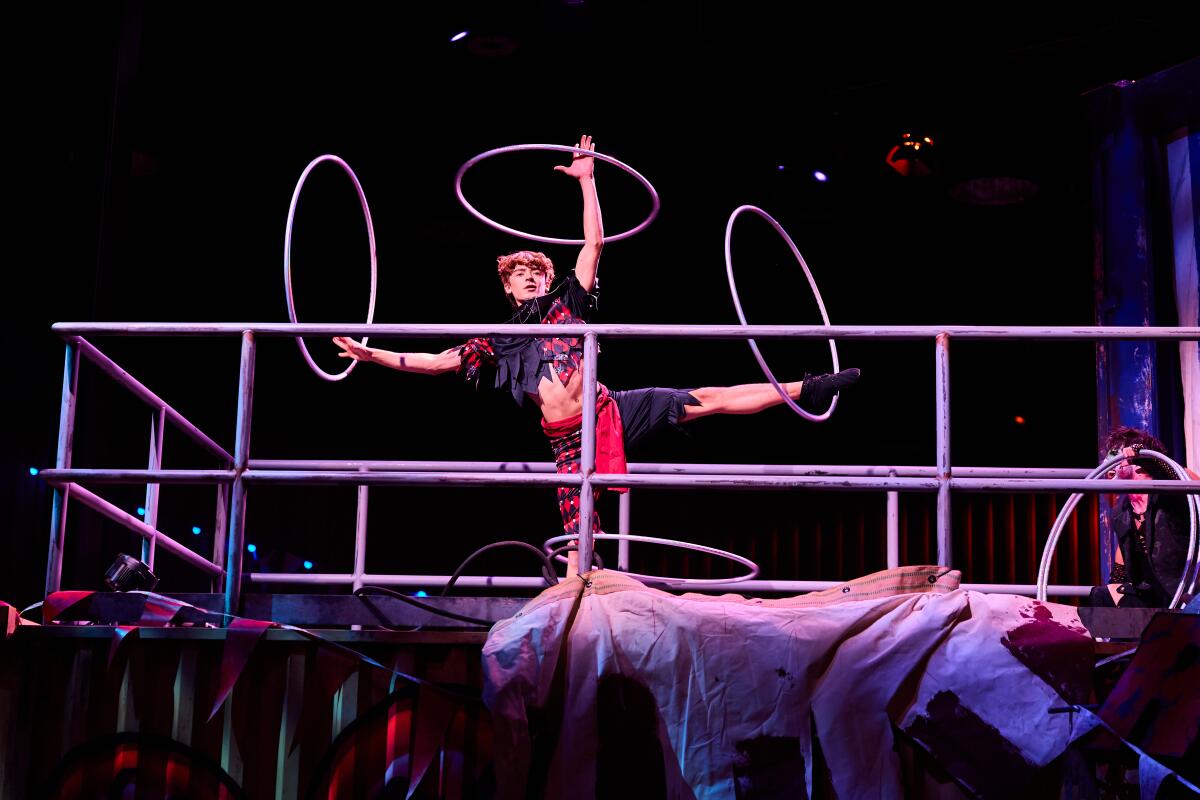 An actor performs with hula hoops.