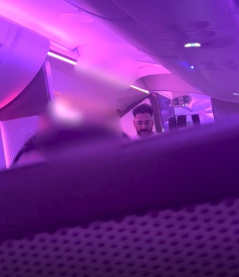 Man in airplane seat.