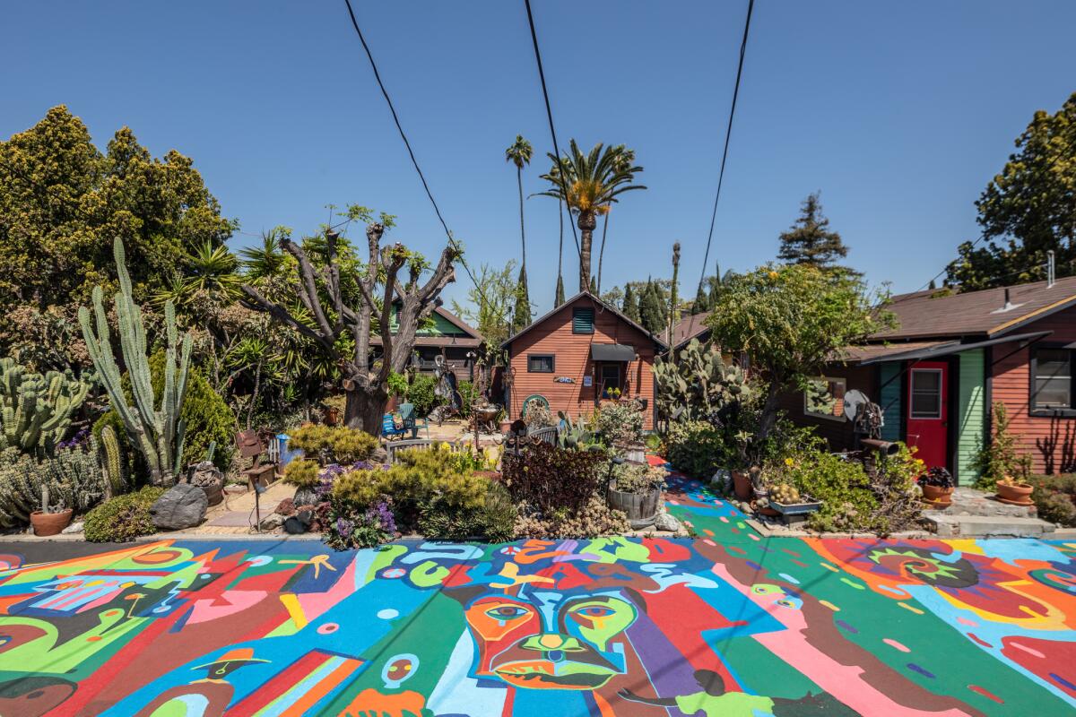 A colorful pathway in a community with clay-colored homes.