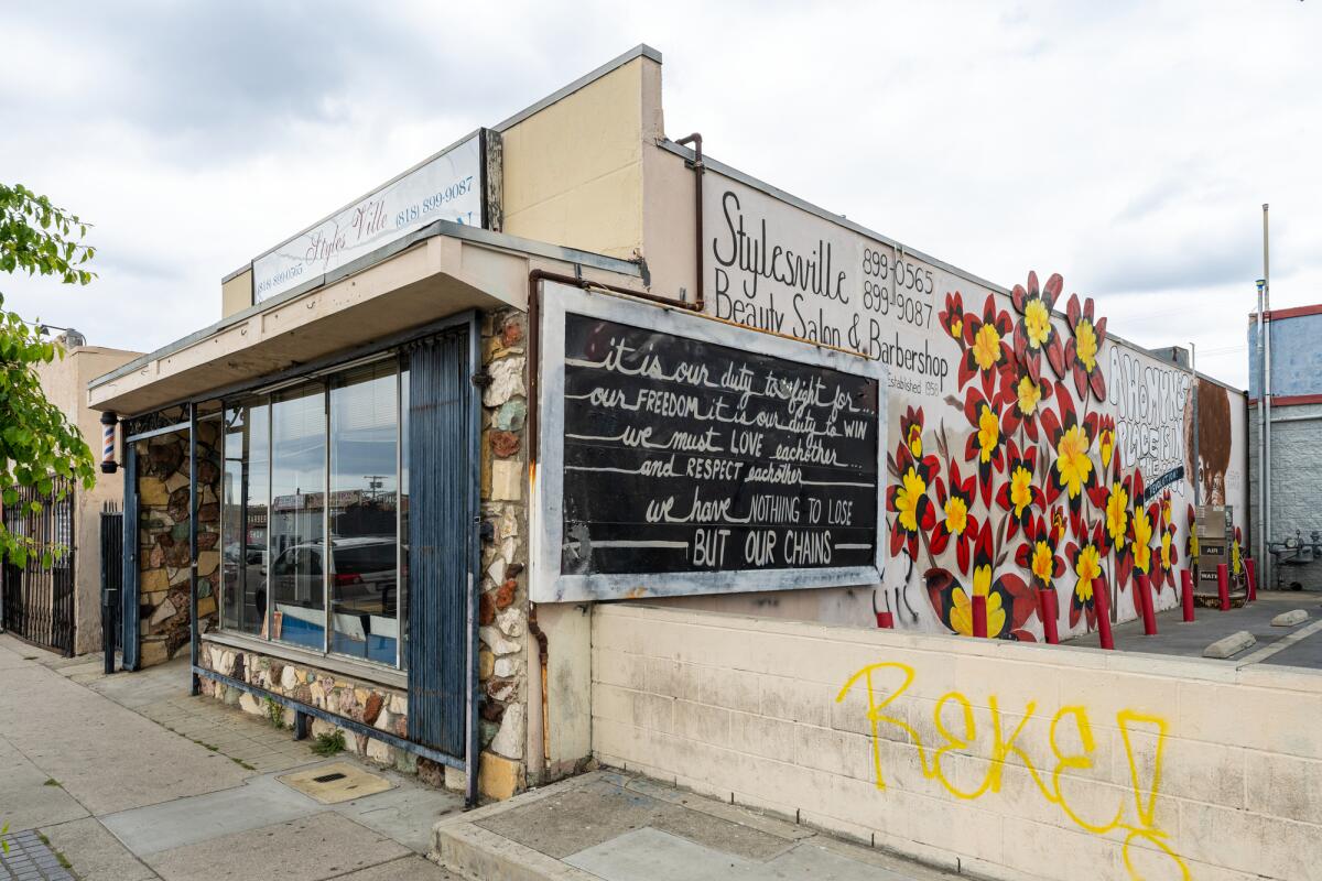 Stylesville Barbershop & Beauty Salon, with a flower mural on its side. 